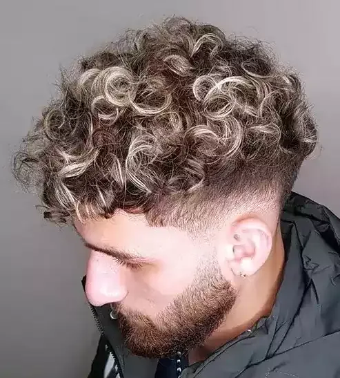 Dare To Be Cool With Loose Blonde Curls, A Low Taper, And A Beard!