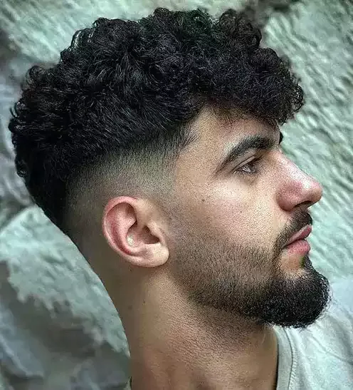 Find Balance And Style With A Mid Fade Curly Haircut, Where The Contrast Of The Fade Complements The Longer Curls On Top