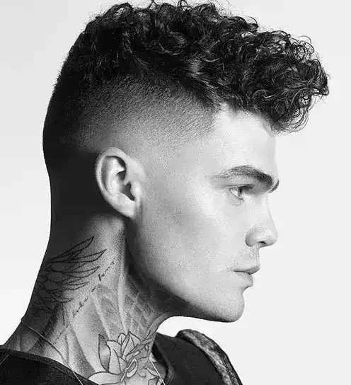 Stand Out With A Catchy Contrast Dimensional, Messy Curly Hair Paired With A High Undercut Fade!
