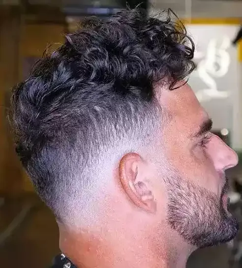 A Long Curly Top With A Low Bald Fade Looks Maculine