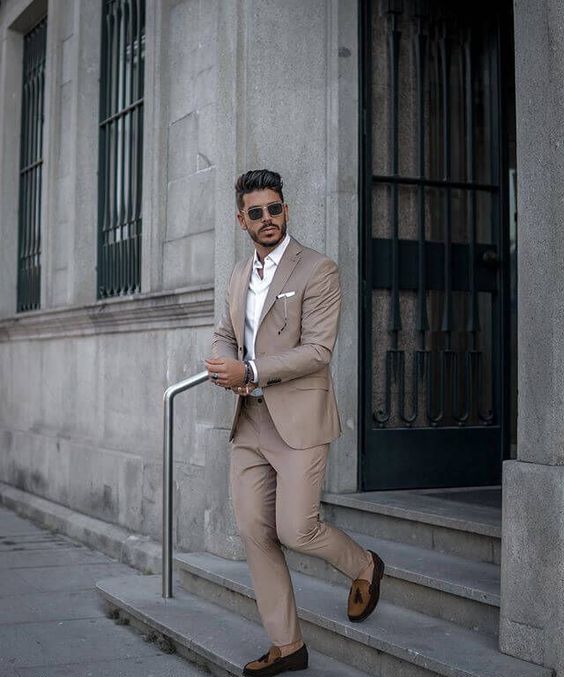 A beige suit a white button down brown moccasins are summer wedding classics that always works