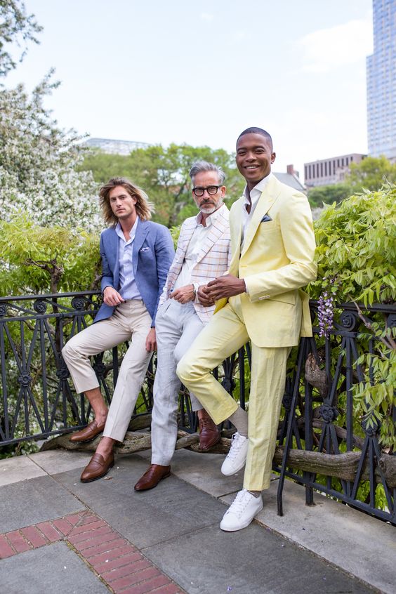 A bold yellow suit neutral pants and a blue and striped blazer brown shoes and white sneakers all these looks are great for summer nuptials