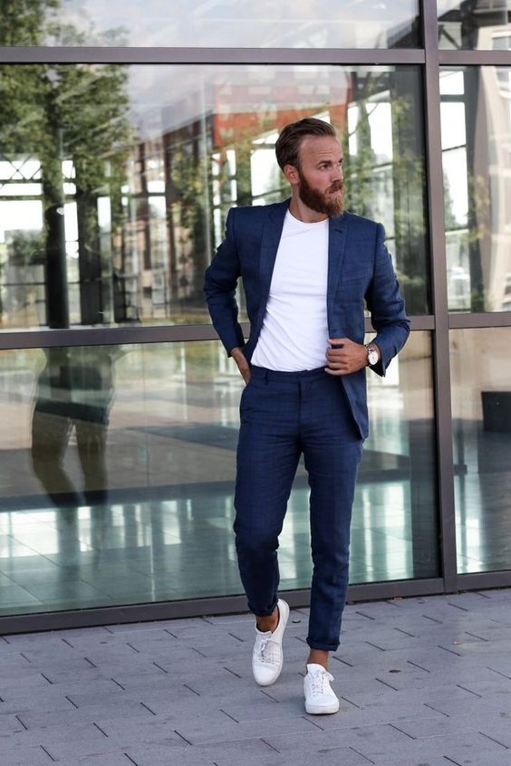 A navy linen suit is a classic idea for summer and a white t shirt and sneakers will give a modern feel to the outfit