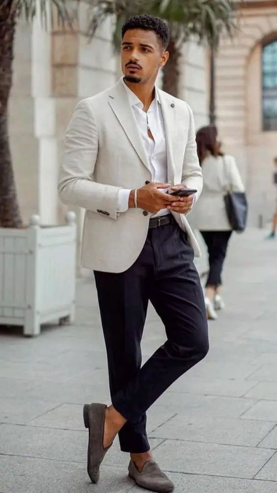 A refined summer look with a white shirt navy pants a creamy blazer grey moccasins is comfy and cool