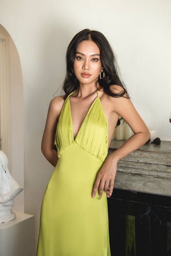 A zesty yellow dress with a pleated bodice and deep neckline is a cool idea for summer celebrations